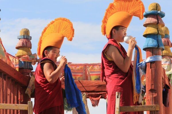 Young monks blowing conch shell in the morning in Erdene Zuu